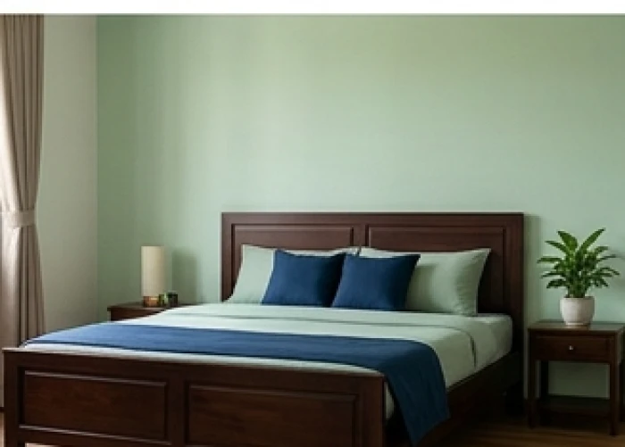 Phòng ngủ 15m2 hài hòa với sơn tường màu xanh ngọc dịu nhẹ và bộ chăn ga điểm nhấn màu xanh biển