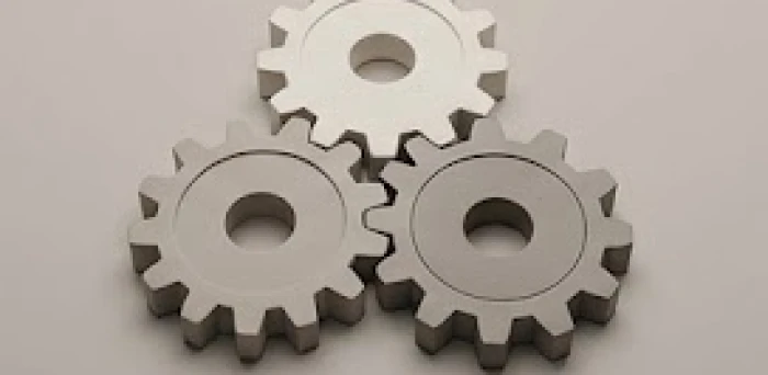 Ba mảnh ghép bánh răng hình khối kết nối hoàn hảo tượng trưng cho sự hợp tác làm ăn thuận lợi