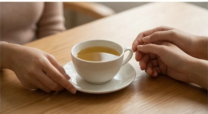 Ly nước ấm đặt nhẹ nhàng trên bàn cùng cử chỉ quan tâm ân cần để hóa giải sự im lặng và kết nối lại