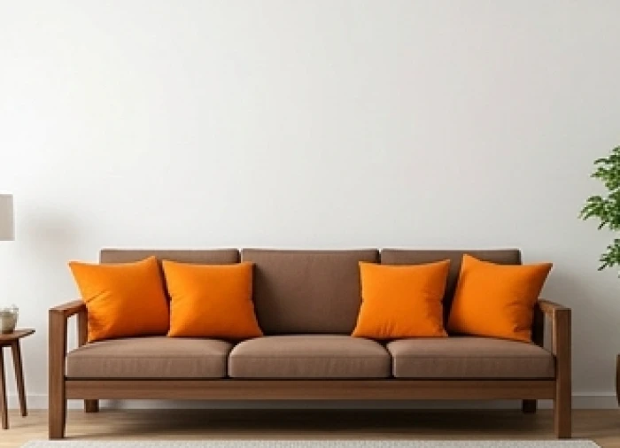 Phòng khách áp dụng công thức 60-30-10 với tường trắng, sofa nâu và gối tựa cam cho tuổi canh ngọ 1990